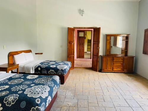 Ένα ή περισσότερα κρεβάτια σε δωμάτιο στο HOTEL EX HACIENDA EL MOLINO