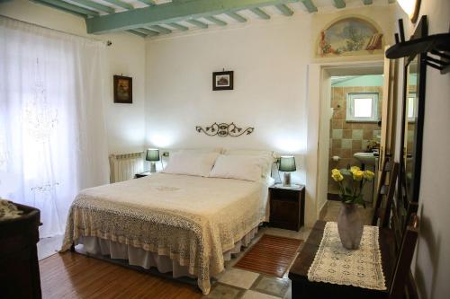 a bedroom with a bed and a vase of flowers at B&B Natalia in Gualdo Tadino