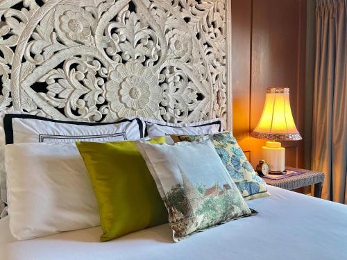 a bed with three pillows on top of it at Bann at Oak Knoll Napa in Napa