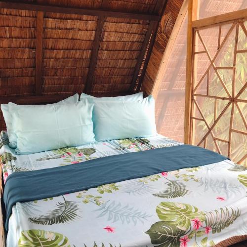 a bed in a room with a bed sidx sidx sidx at The Cabins at LVF in Puerto Princesa City