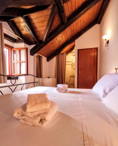 a large white bed with a towel on it at Villa Moro House in Milna