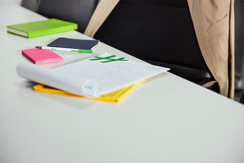 a desk with a book and pens and notebooks at Holiday Inn Gatineau - Ottawa by IHG in Gatineau