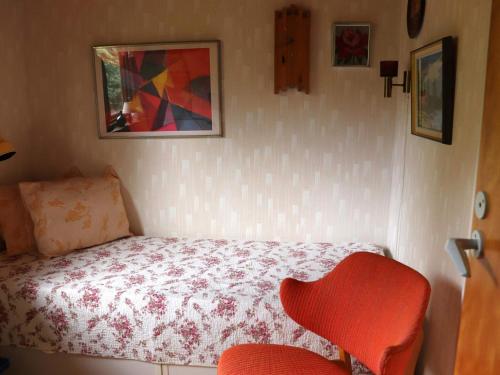 a small bedroom with a bed and a chair at 5 person holiday home in KNÄRED-By Traum in Knäred
