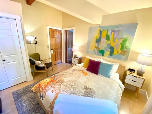 a bedroom with a bed and a chair in it at Bell In The Woods B&B in Seward