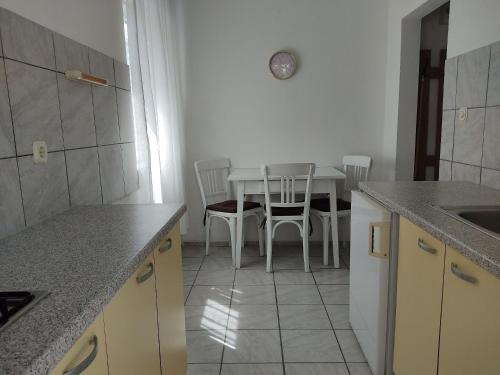 a kitchen with a table and a table and chairs at House House Povile in Povile