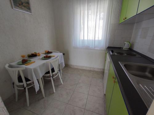 a small kitchen with a table with food on it at House House Povile in Povile