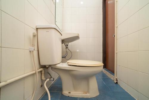a bathroom with a white toilet in a stall at RedDoorz @ Glodok in Jakarta