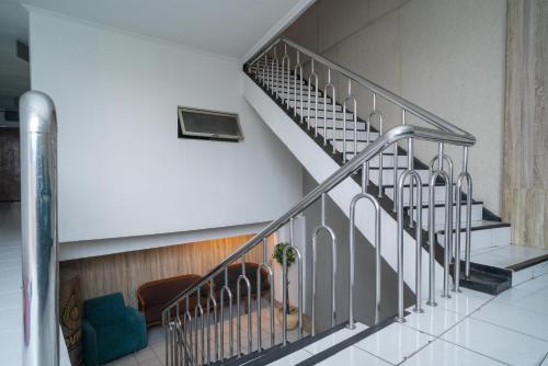a staircase in a building with a potted plant at RedDoorz @ Glodok in Jakarta
