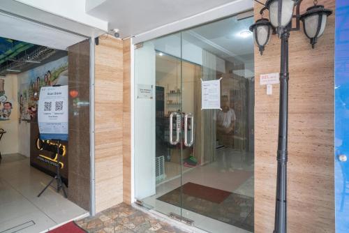 a store front with a glass door and a light pole at RedDoorz @ Glodok in Jakarta
