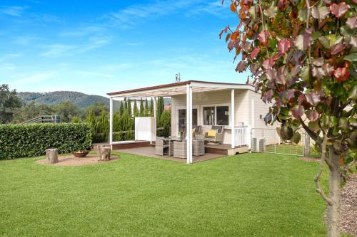 a backyard with a pavilion with a lawn at The Cottage Sojourn Kangaroo Valley in Kangaroo Valley