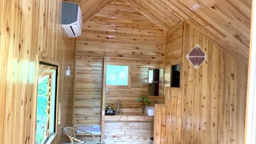a wooden cabin with a wall of wood at Nobita Homestay bắc hà in Bắc Hà