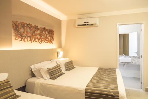 a hotel room with a bed and a window at Lagoon Prime Hotel in Lagoa Santa