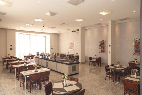 a restaurant with tables and chairs in a room at Lagoon Prime Hotel in Lagoa Santa