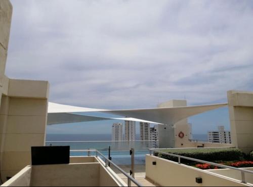 a view of the ocean from the balcony of a building at Apartamento - Velas al Mar, Santa Marta in Gaira