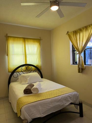 a bedroom with a bed with towels and a window at Casa Dolores in Dolores Hidalgo
