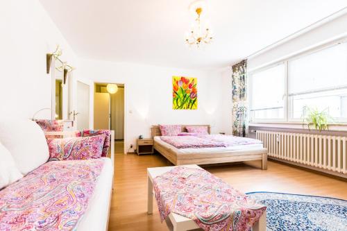 a living room with two beds and a couch at CGN Apartments - Altstadt süd in Cologne