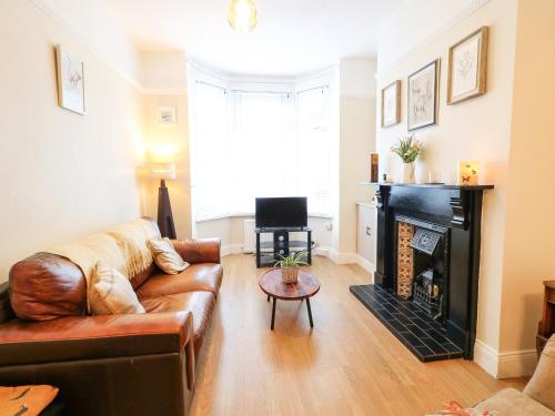 a living room with a couch and a fireplace at Number 91 in Belfast