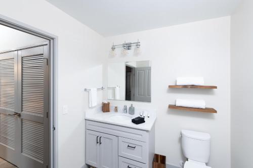 a white bathroom with a sink and a toilet at Flexhome Brewery District 1BR Apt M5 - READ INFO in Milwaukee