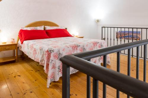 a bedroom with a bed with a red pillow at Casa Resilienza Vico Equense - 5 min dal mare in Vico Equense