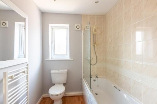 a bathroom with a toilet and a bath tub at Number 4 in Bishop Auckland