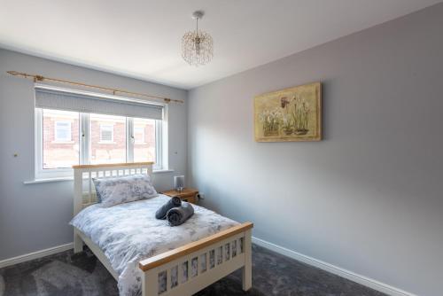 a bedroom with a bed with a stuffed animal on it at Number 4 in Bishop Auckland