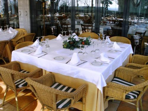 
a dining room table set with chairs and tables at Hospedium Hotel Los Lanceros in San Lorenzo de El Escorial
