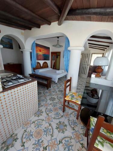 a living room with a stove and a room with a bed at Appartamenti Iacono in Forio d'Ischia