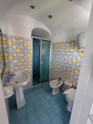 a bathroom with two sinks and a toilet and a shower at Appartamenti Iacono in Forio d'Ischia