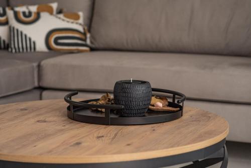 a candle on a coffee table in front of a couch at Mystic Garden Villas in Zakynthos Town