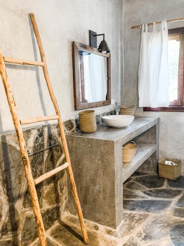 a bathroom with a counter with a sink and a mirror at Villa Nakupenda with Pool and Ocean view in Kiwengwa