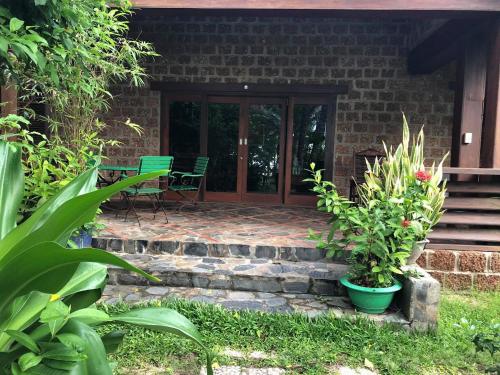 a brick house with a patio with chairs and plants at Full Moon Beach Resort in Mui Ne