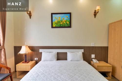 a bedroom with a bed and a picture on the wall at S79 Noi Bai Airport Boutique Hotel in Hanoi