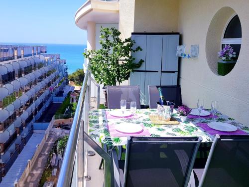 a table on a balcony with a view of the ocean at AptoVistas al mar-Font de Mar en Cap de Salou in Salou