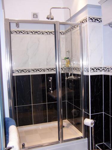 a shower with a glass door in a bathroom at Foundry Masters House in Ironbridge