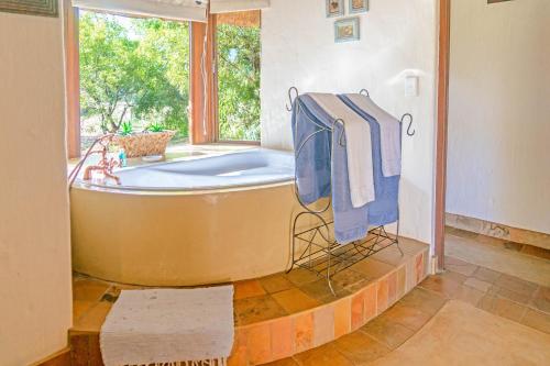 a large bathroom with a tub and a window at Zebula 115 in Mabula