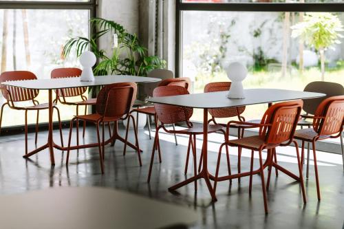 a group of tables and chairs in a room at Hotel Septembar in Podgorica