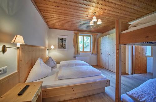 a bedroom with two bunk beds and a desk at Sportpension Enzian in Saalbach Hinterglemm