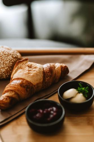 a table topped with bread and two bowls of dips at Hotel Septembar in Podgorica