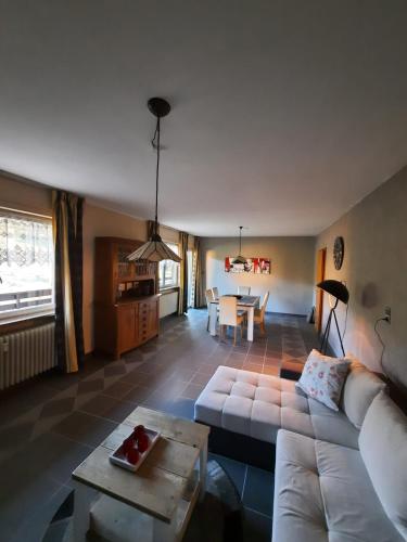 a living room with a white couch and a table at Ferienwohnungen Joop in Biersdorf am See