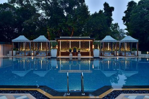 a swimming pool with a building with lights at Taj Mahal, New Delhi in New Delhi