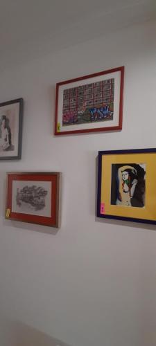 a group of pictures on a white wall at Dúplex Navarrería Estella UATO1004 in Estella