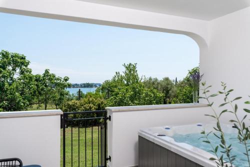 a hot tub on the balcony of a house at Holiday Home Saladinka with Whirlpool in Poreč