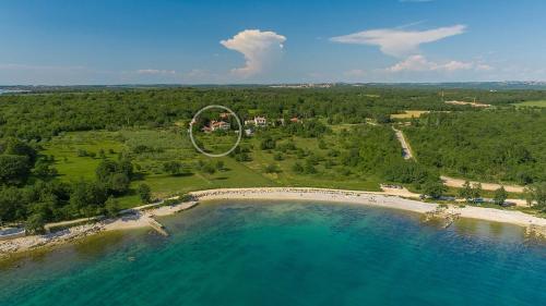 an aerial view of a beach with a large ring in the water at Holiday Home Saladinka with Whirlpool in Poreč