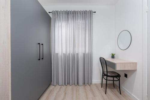 a room with a desk and a chair next to a curtain at Holiday Home Saladinka with Whirlpool in Poreč