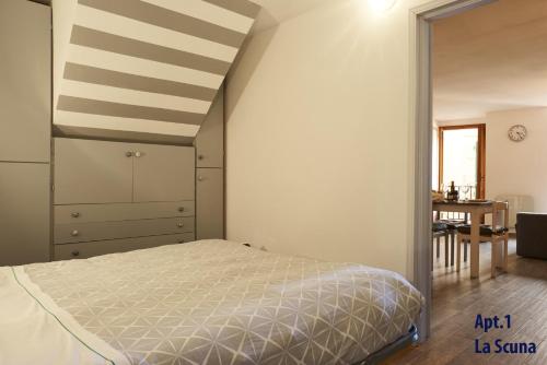 a bedroom with a bed and a table in a room at La Scuna Apartments in Corniglia