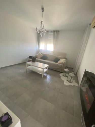 a living room with a couch and a table at Location T3 entier à 5 minutes de l’aéroport in Marignane