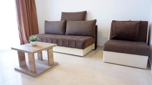 a living room with a couch and a chair at Ponte Apartments in Ulcinj