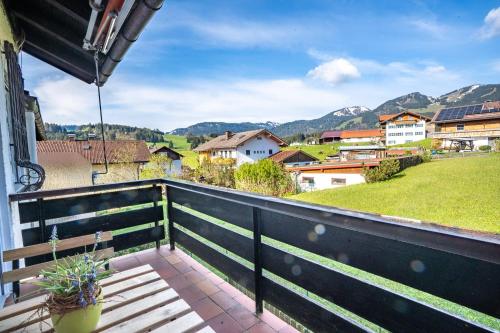 a balcony with a view of a village and mountains at Hörnerwiesen in Fischen