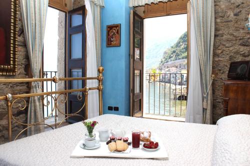 a plate of food sitting on a table with a window at Principe Di Scilla in Scilla