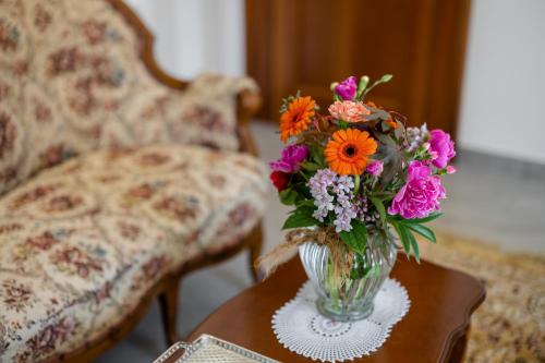 a vase of flowers sitting on a table at Kotnik Superior Boutique Hotel in Kranjska Gora